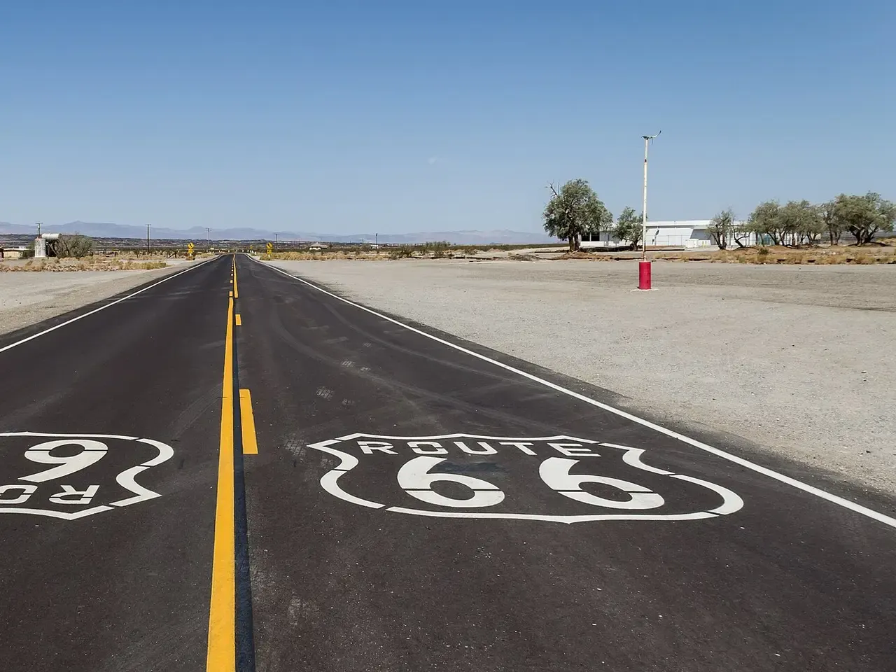 Open Route 66 highway running straight across the Mojave High Desert