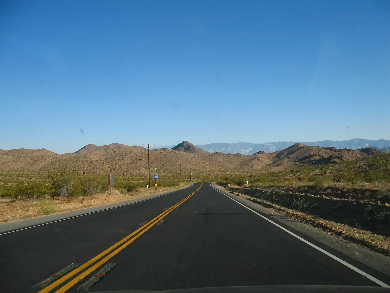 Open High Desert highway heading toward the mountains